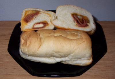 Two pepperoni roll brands of (sliced) pepperoni rolls, one with cheese and one without.